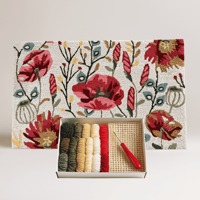 Floral-patterned rug with yarn and tools on a matching box