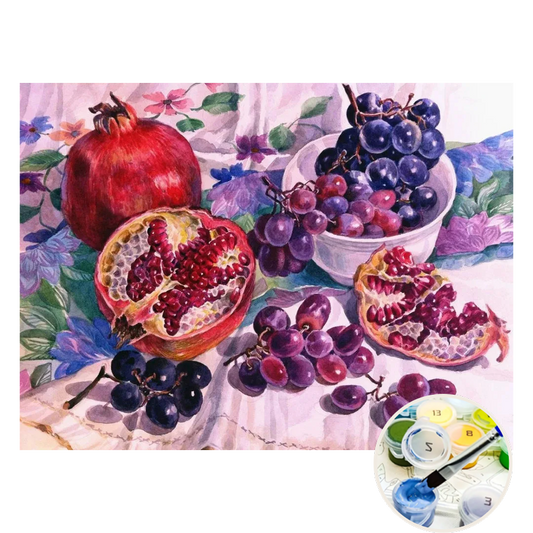 Still life painting of pomegranates and grapes with a color wheel in the corner.