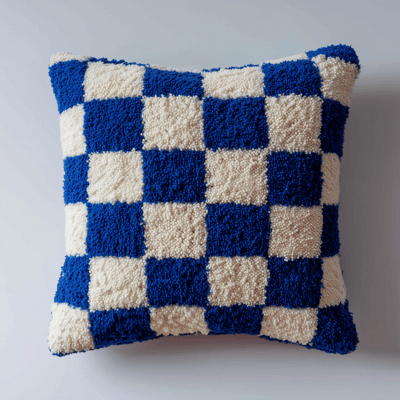 Checkered blue and white pillow on a light gray background