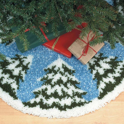Decorative Christmas tree skirt with a winter scene design, placed under a Christmas tree.
