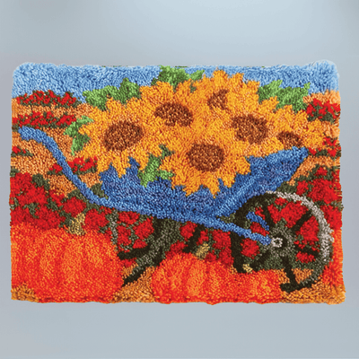 Decorative rug with sunflowers and a wheelbarrow design on a gray background