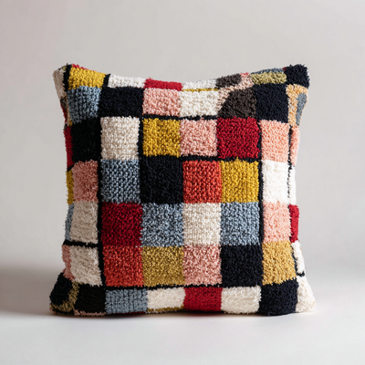 Multicolored checkered pillow on a light gray background
